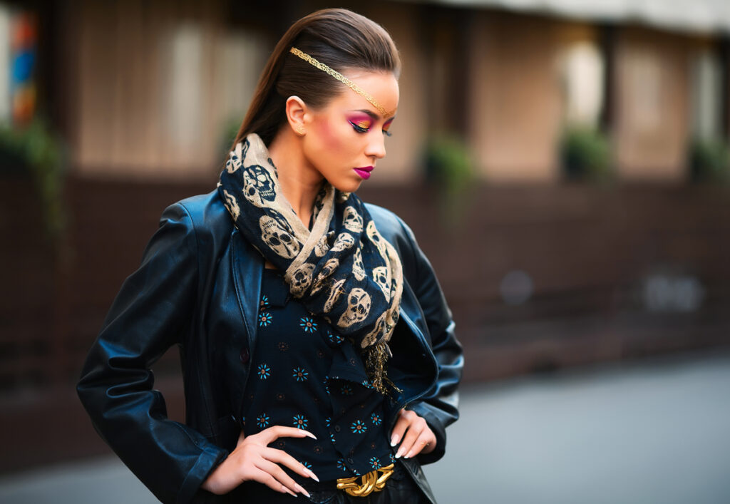 young stylish woman against old building wall